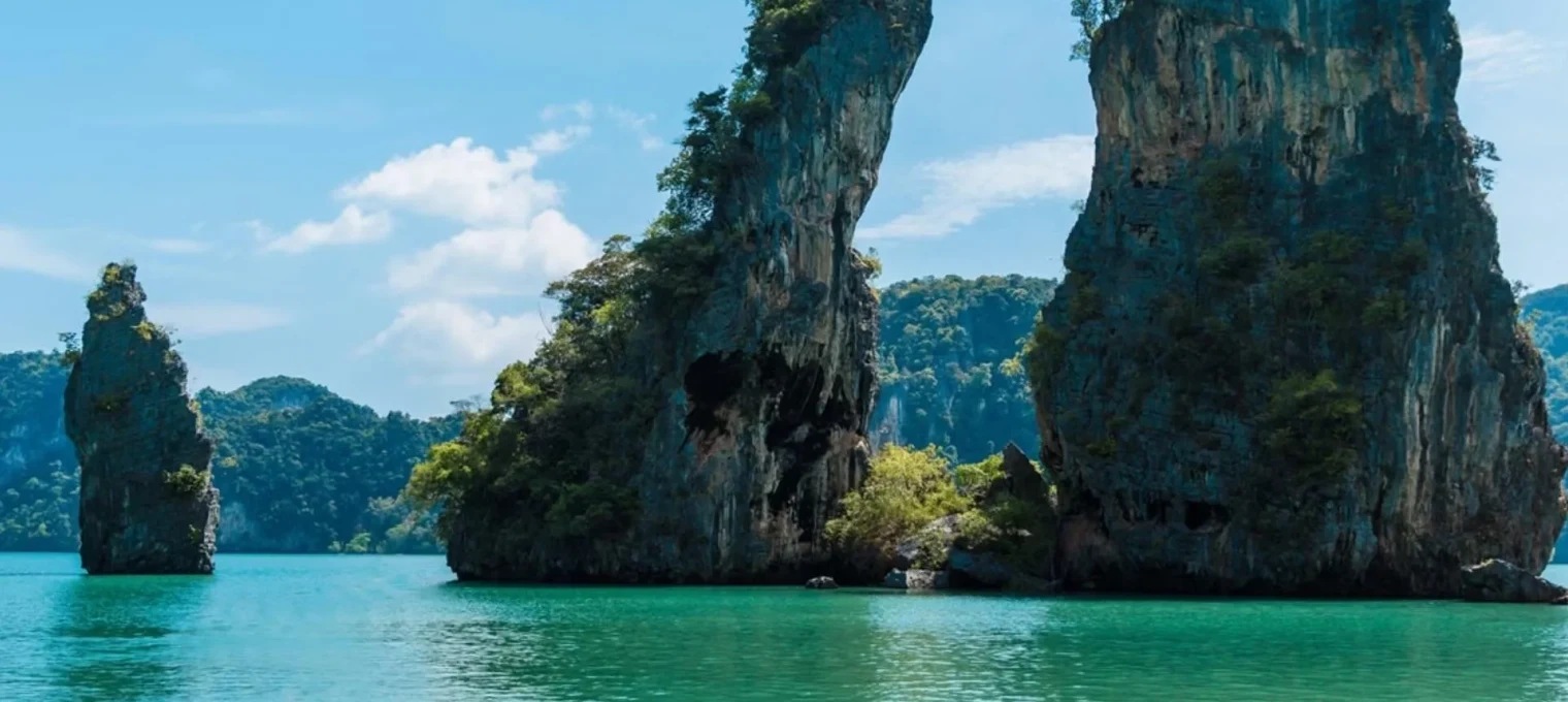 Stunning limestone cliffs rise above crystal-clear turquoise waters in Phuket.