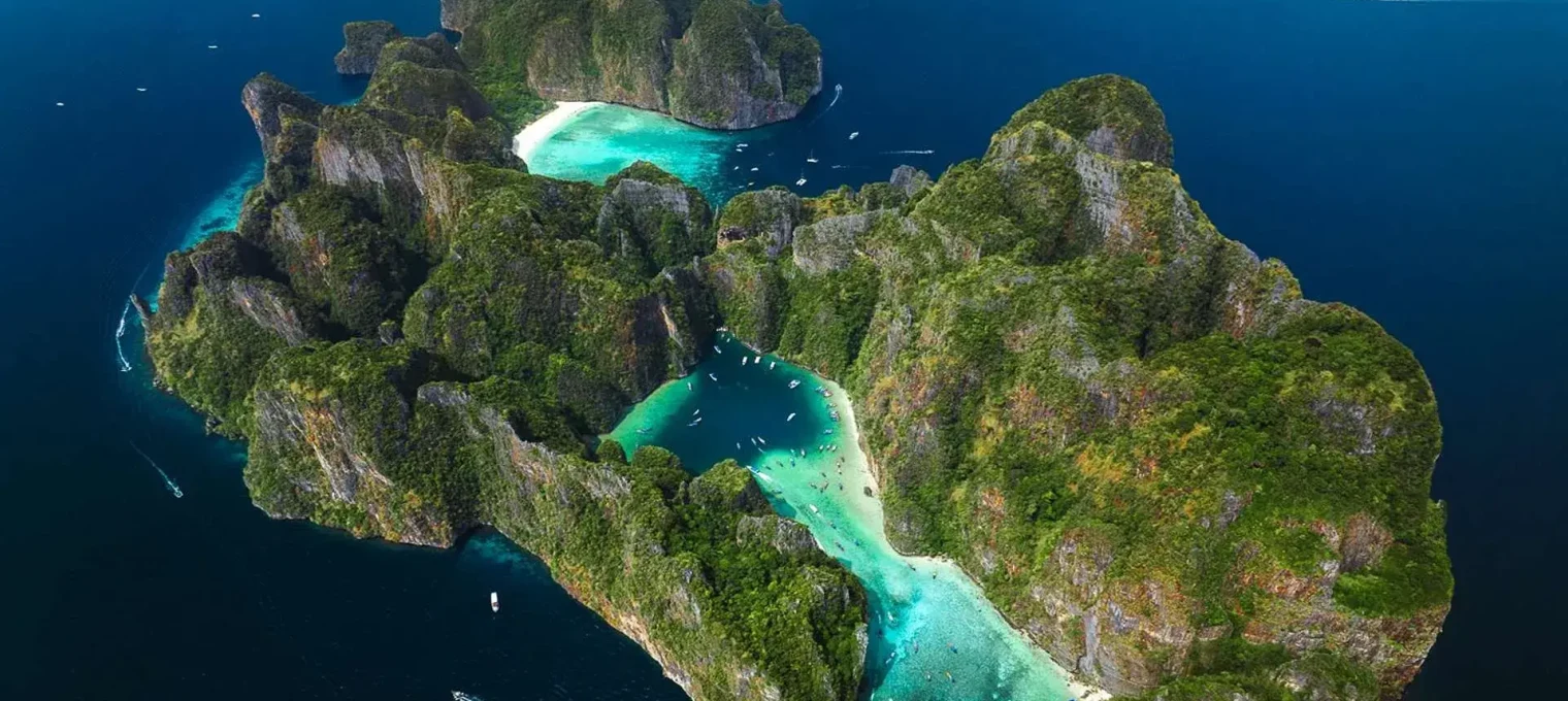Aerial view of lush islands and turquoise waters in Phuket, Thailand.