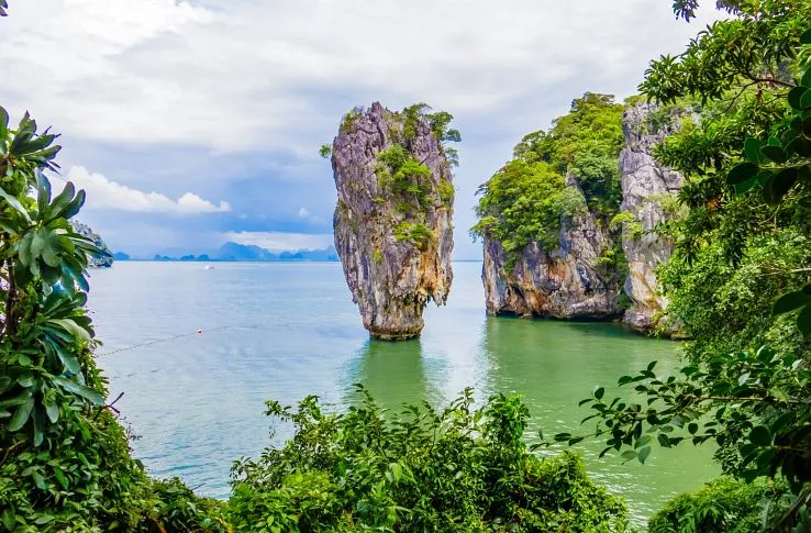 Scenic view of limestone cliffs and emerald waters in Phuket, Thailand.
