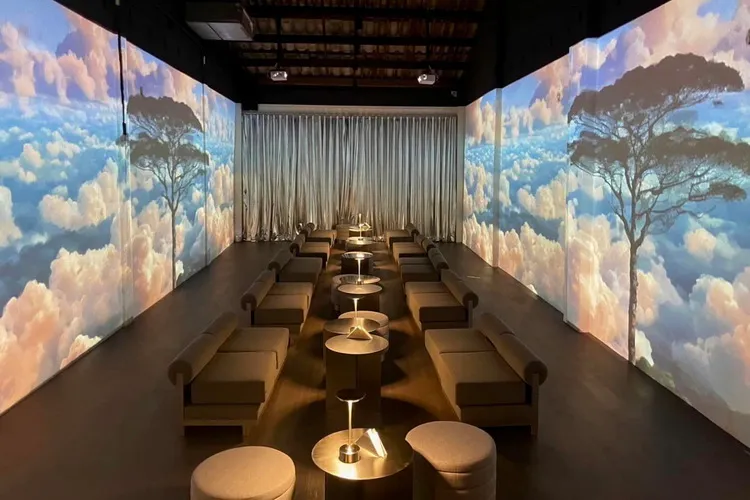 Modern lounge with cloud projections, cozy seating, and ambient lighting in Phuket.
