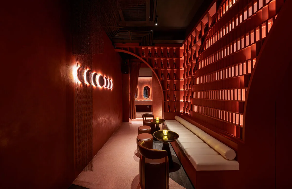 Stylish interior of a bar in Phuket with red tones and modern decor.