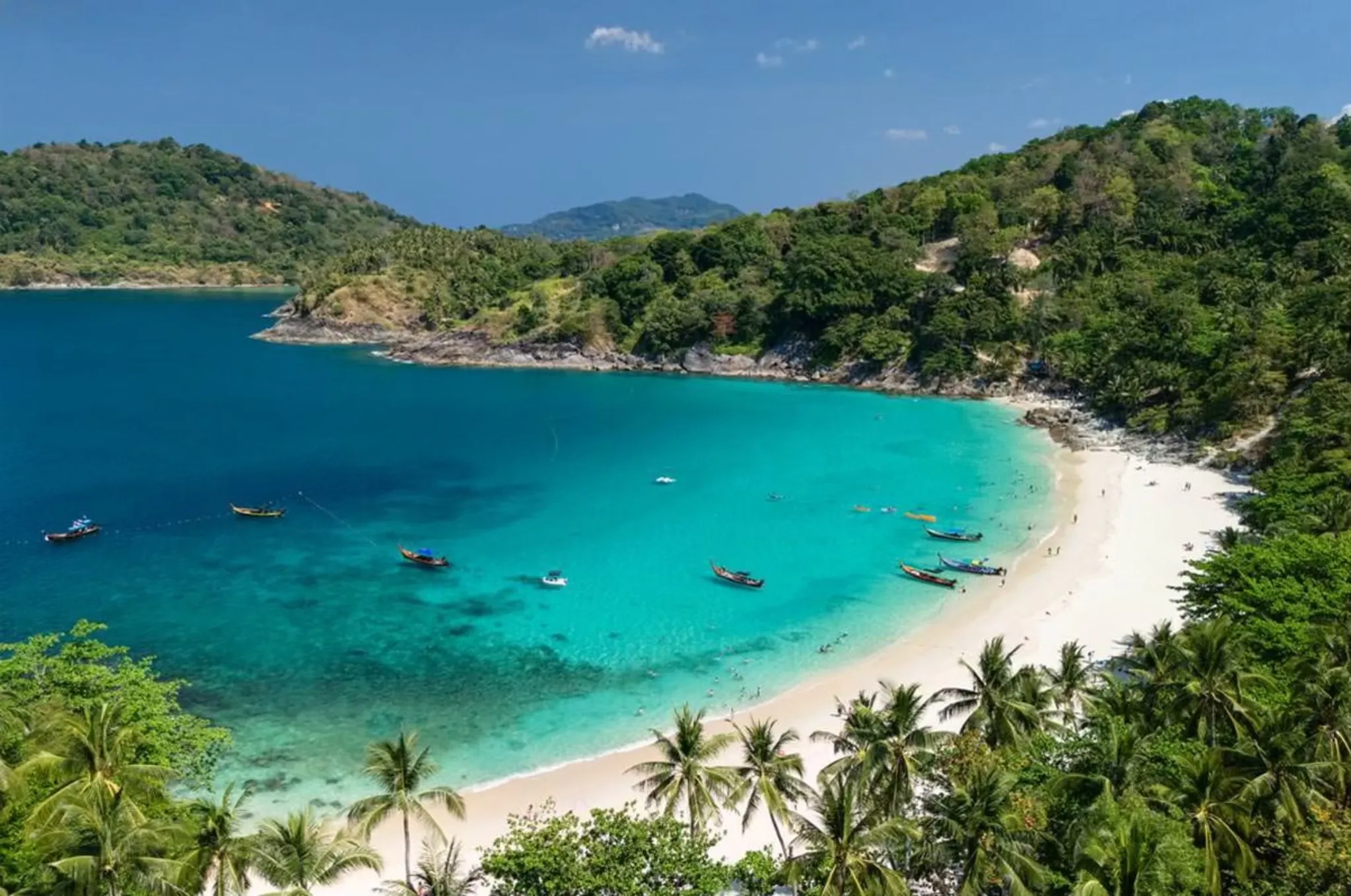 Stunning view of a tropical beach in Phuket with turquoise waters and lush greenery.