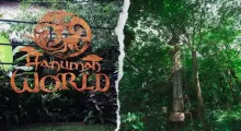 Colorful sign for Hanuman World amidst lush greenery in Phuket, Thailand.