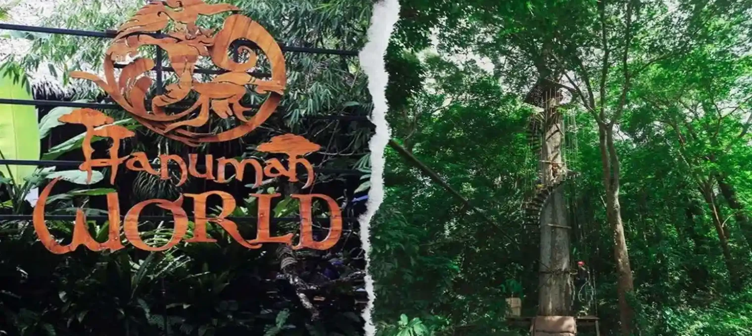 Colorful sign for Hanuman World amidst lush greenery in Phuket, Thailand.