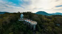 A scenic view of a tower overlooking lush greenery in Phuket, Thailand.