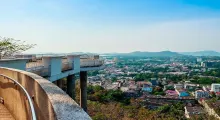 Scenic view of Phuket from a viewpoint with city and mountains in the distance.