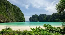 Stunning beach view in Phuket with lush cliffs and clear turquoise water. Perfect tropical paradise.