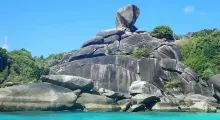 Large rock formation known as the "Boulder" on a tropical beach in Phuket, Thailand.