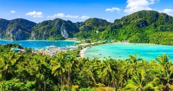 Stunning view of turquoise waters and lush mountains in Phuket, Thailand.