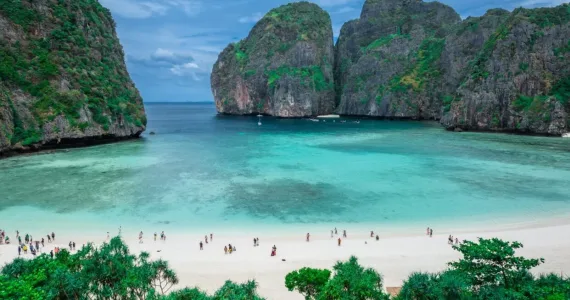 Stunning view of turquoise waters and rocky cliffs at a beach in Phuket, Thailand.