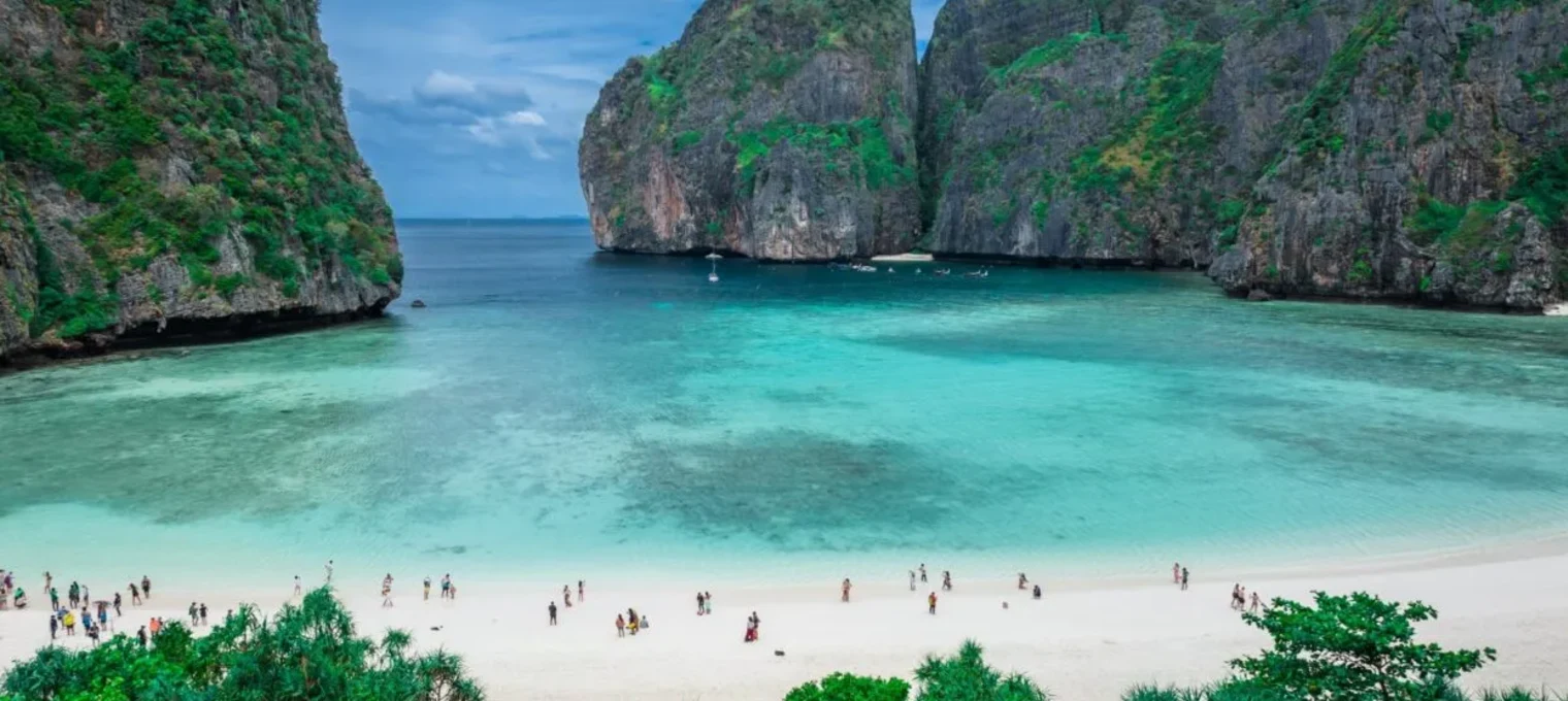 Stunning view of turquoise waters and rocky cliffs at a beach in Phuket, Thailand.