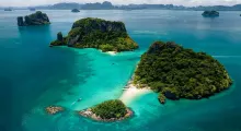 Aerial view of lush islands and turquoise waters near Phuket, Thailand.