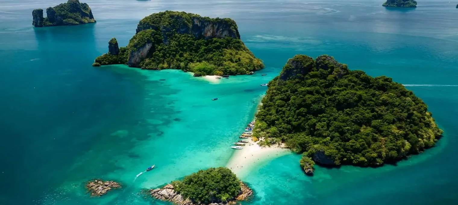 Aerial view of lush islands and turquoise waters near Phuket, Thailand.