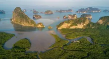 Stunning aerial view of lush mangroves and rocky islands in Phuket, Thailand.