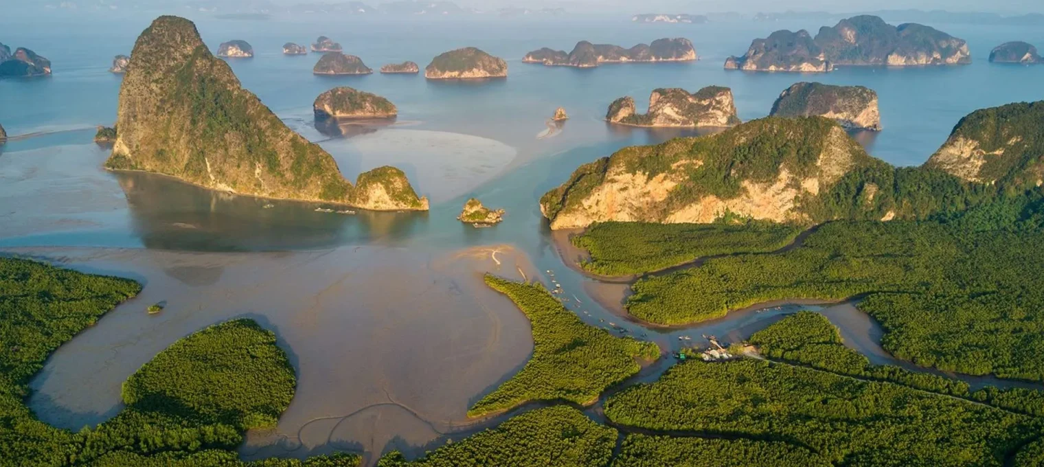 Stunning aerial view of lush mangroves and rocky islands in Phuket, Thailand.