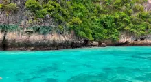 Scenic view of turquoise waters and lush greenery along Phuket's coastline.