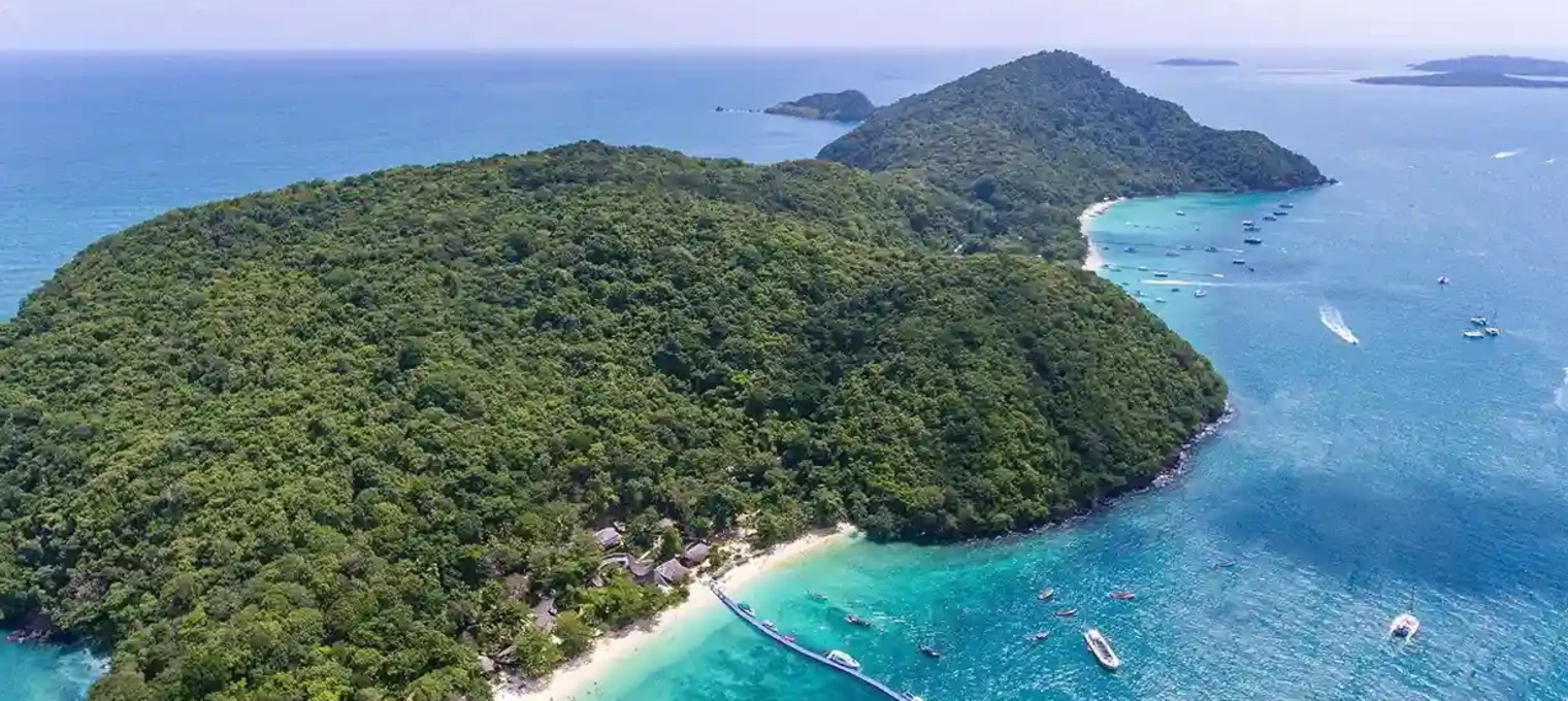 Aerial view of lush green islands and clear blue waters in Phuket, Thailand.