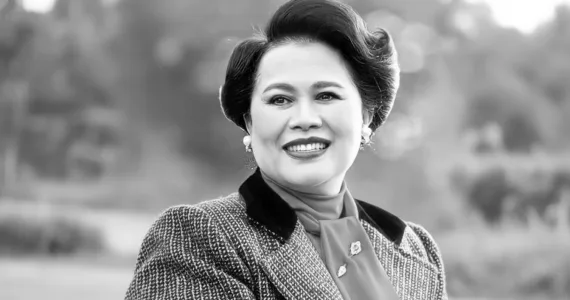 Queen Sirikit in vintage attire posing outdoors in Phuket, Thailand.