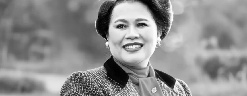 Queen Sirikit in vintage attire posing outdoors in Phuket, Thailand.