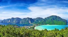 A panoramic view of lush greenery and turquoise waters in Phuket, Thailand.