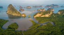 Aerial view of Phang Nga Bay in Phuket, featuring limestone cliffs and lush mangroves.