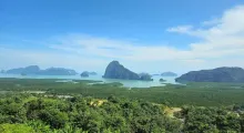 Stunning view of Phang Nga Bay from Phuket, featuring lush greenery and limestone islands.