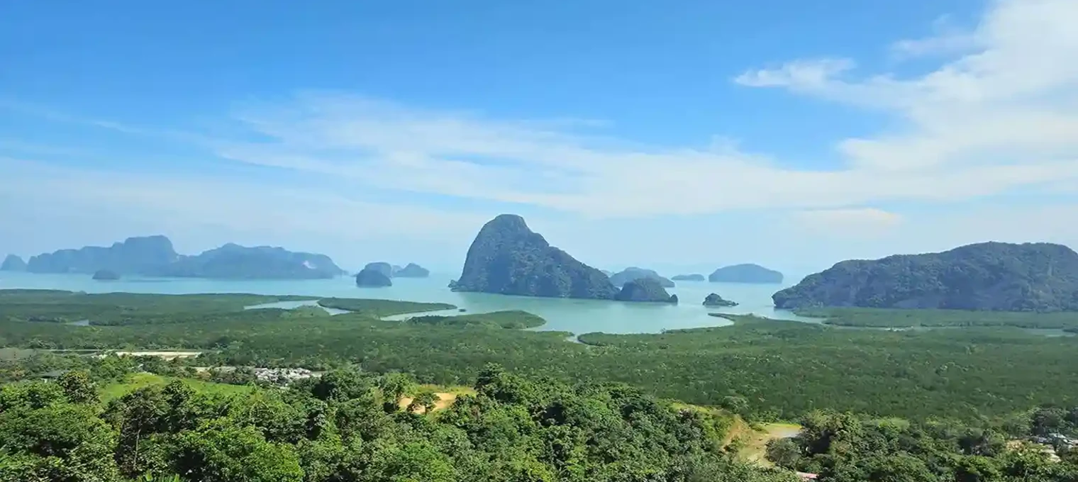 Stunning view of Phang Nga Bay from Phuket, featuring lush greenery and limestone islands.