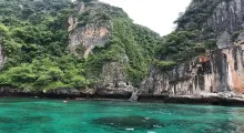 Scenic view of lush cliffs and turquoise waters in Phuket, Thailand.